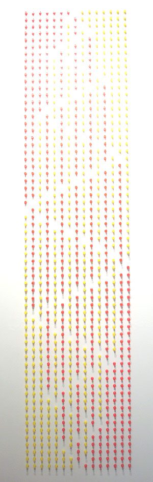 A white background with yellow and red dots.